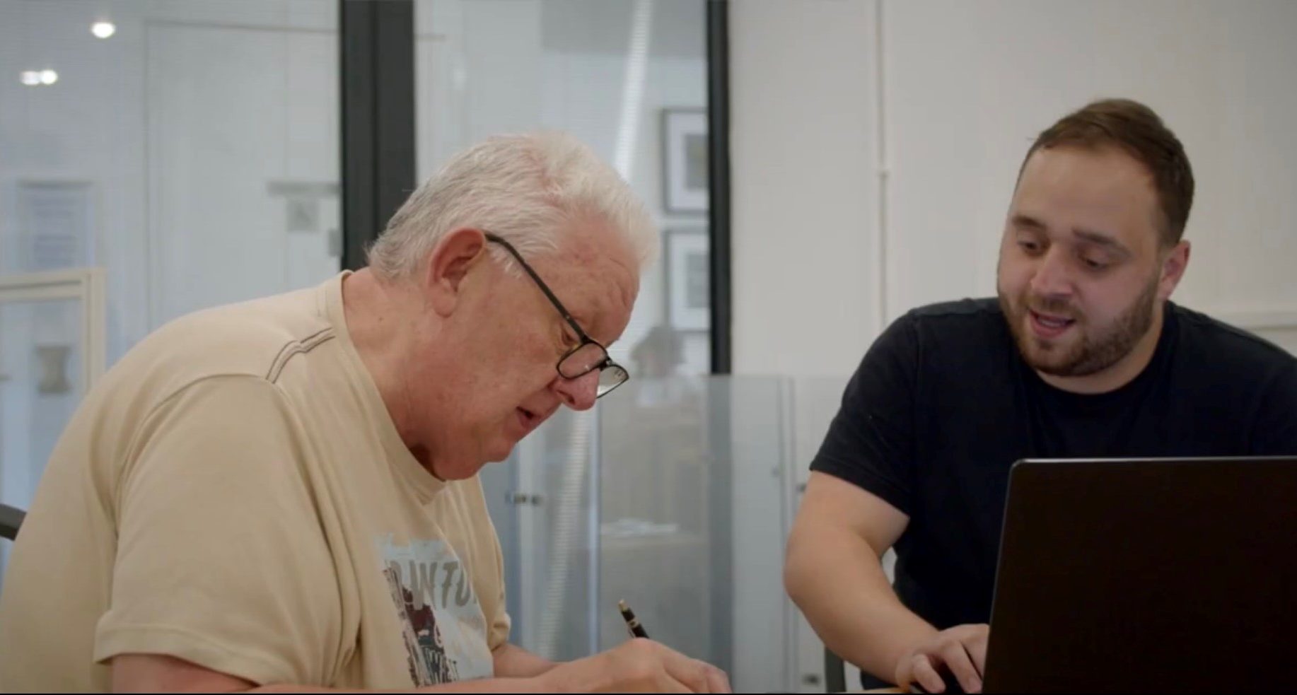 2 men looking at a tablet computer