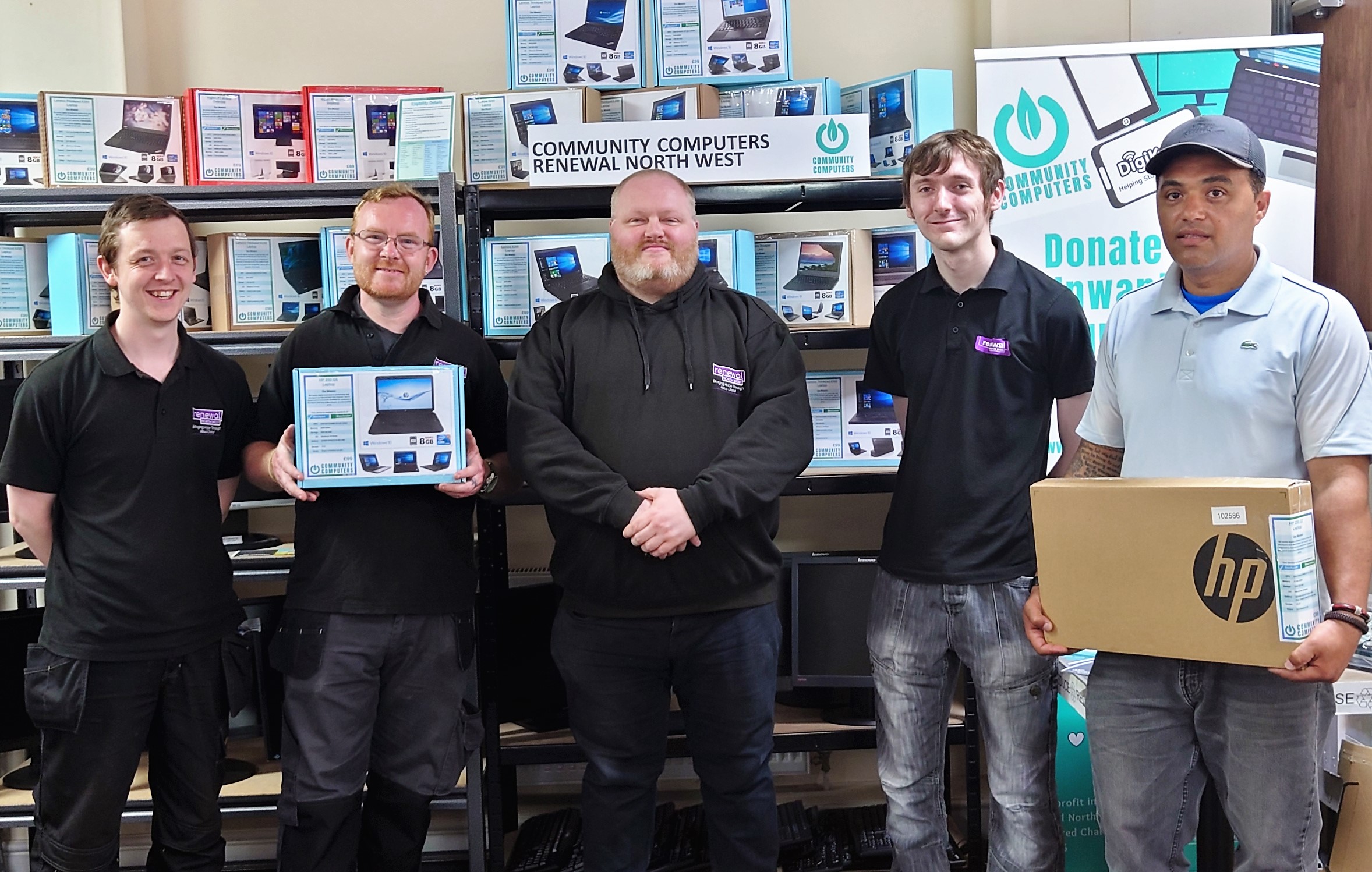 Five men holding refurbished devices