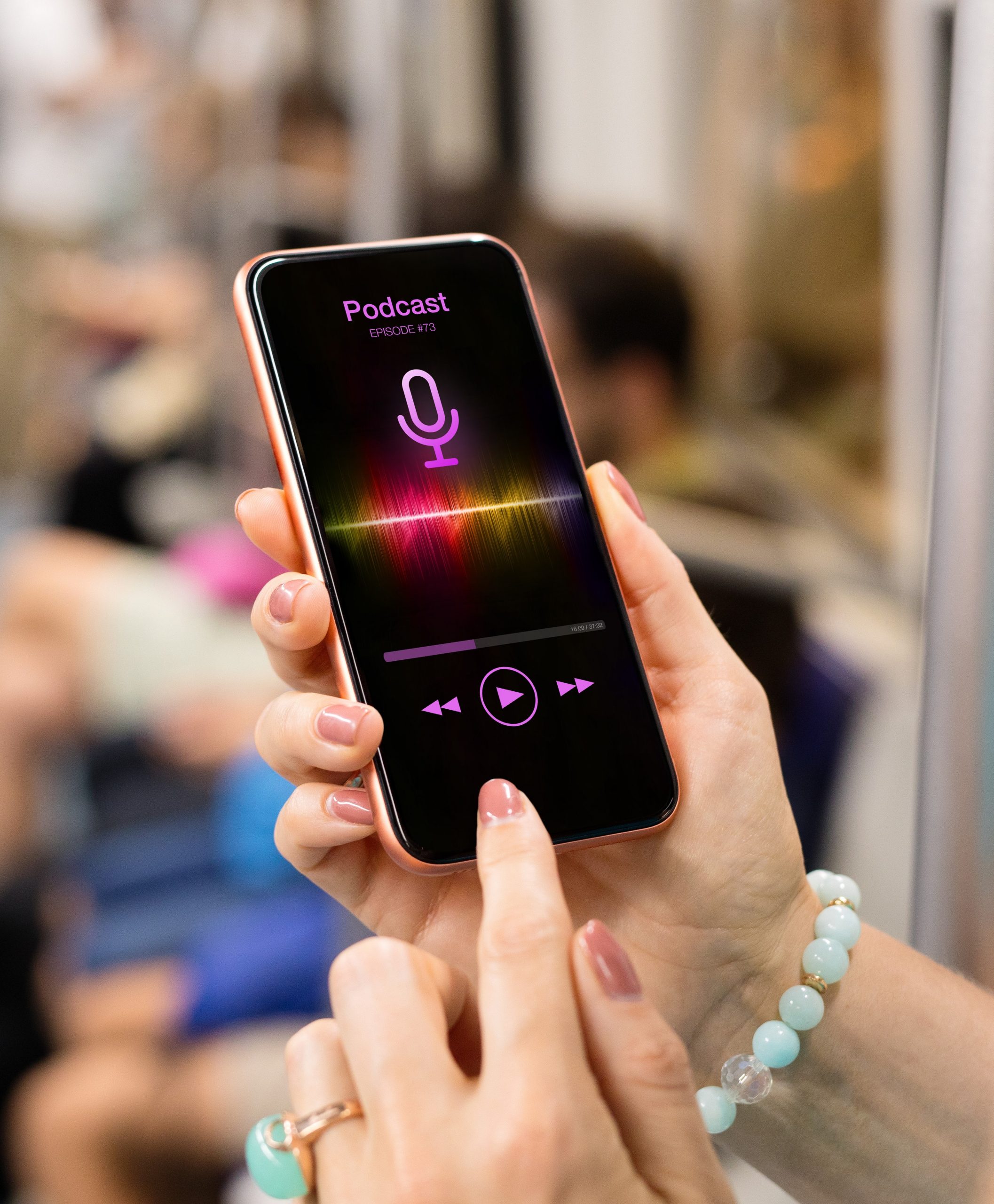 Woman's hands holding a mobile phone with a podcast playing on the screen. Bus interior in background.