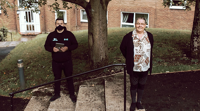 Ryan of Starting Point pictured with a resident outside