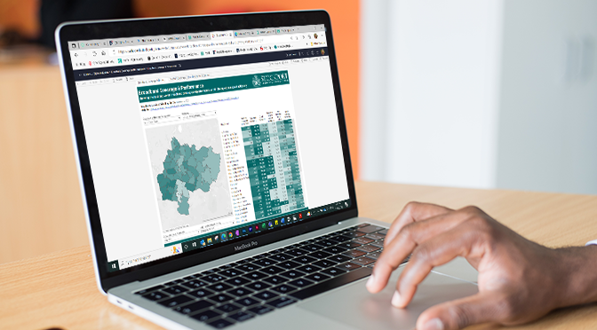 Laptop with image of map of Stockport shaded in different colours and a table