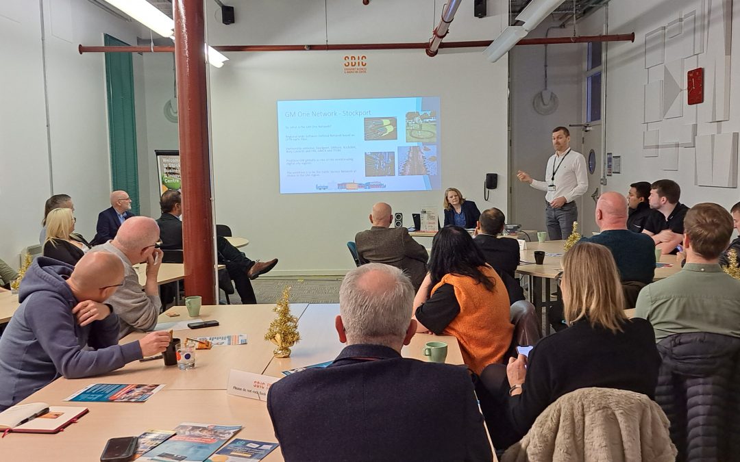 Around 30 people in a room watching a presentation