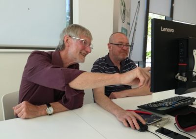 Two men looking at a computer