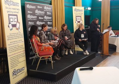 A group of people on a stage as a discussion panel