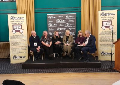 A group of people on a stage as a discussion panel