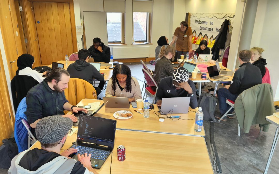 Groups with laptops sat around desks